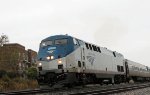 AMTK 2 leads train 80, the Carolinian, away from the station is a light rain 